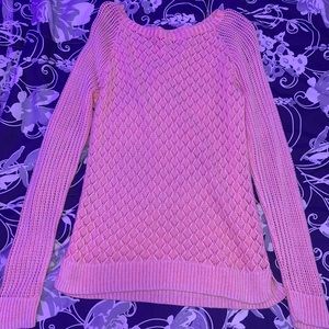 Long sleeve pink top with wholes on it